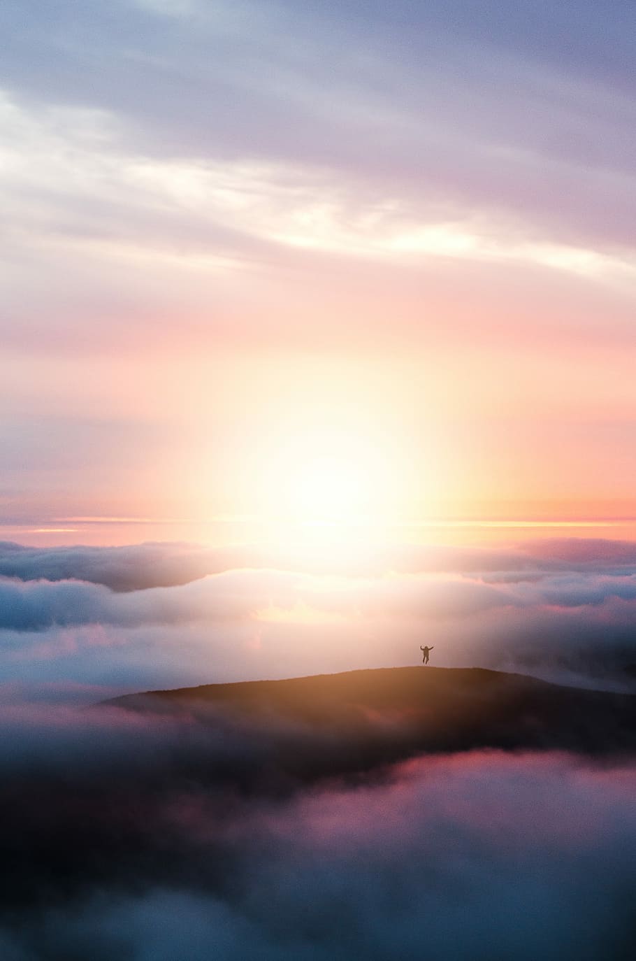 man jumping on hill during golden hour, silhouette photography of person standing on mountain covered with clouds during golden hour HD wallpaper