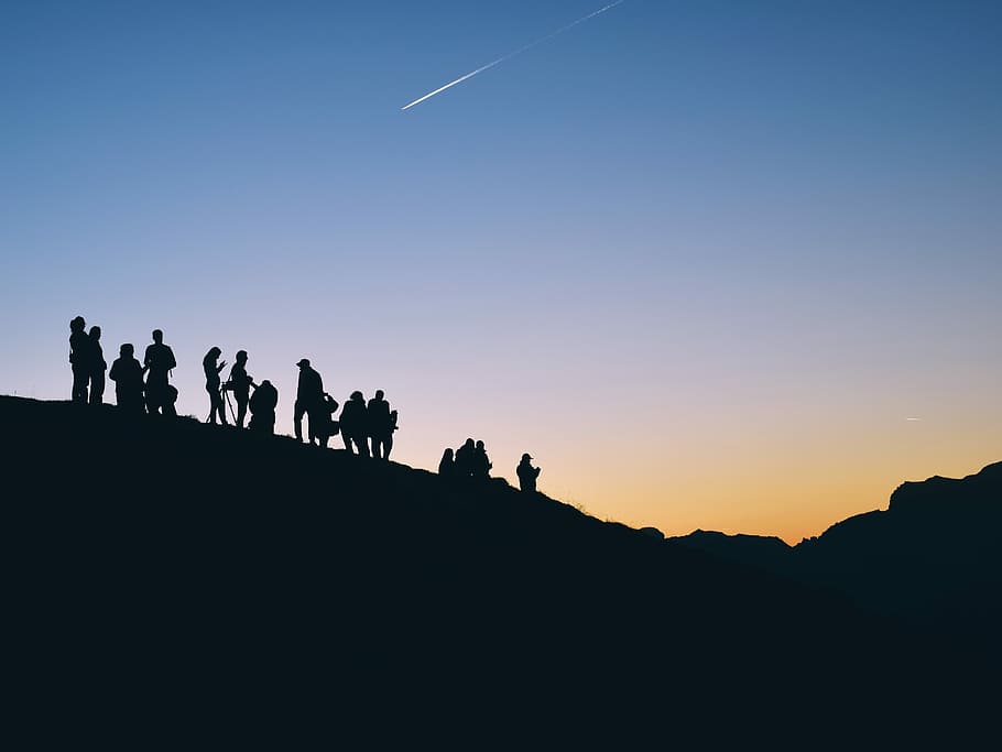 silhouette of people on mountain under falling satr, group of people on top of mountain HD wallpaper