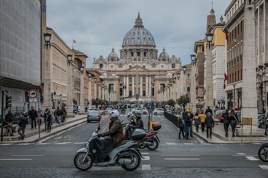 person riding motorcycle on street, saint peter's basilica, pope