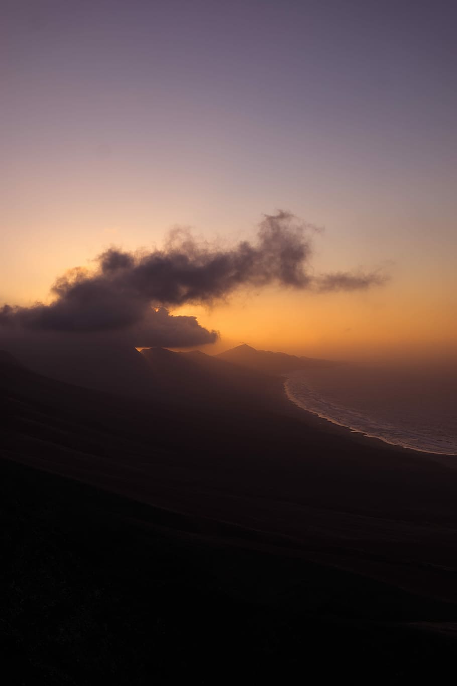 mountain near sea under white cloud during golden hour, hills near seashore at dusk HD wallpaper