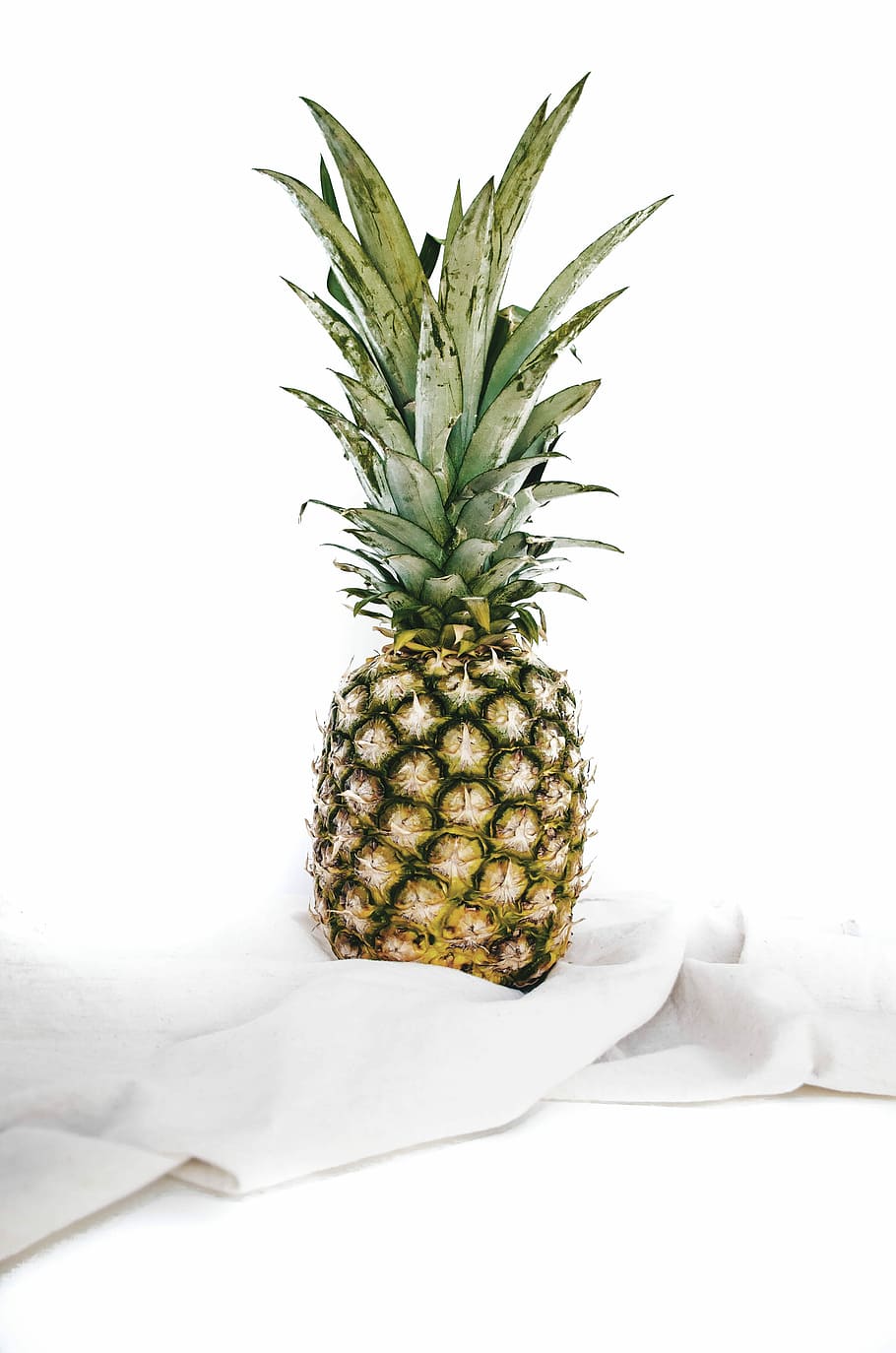 yellow and green pineapple fruit on white textile, pineapple on white cloth HD wallpaper