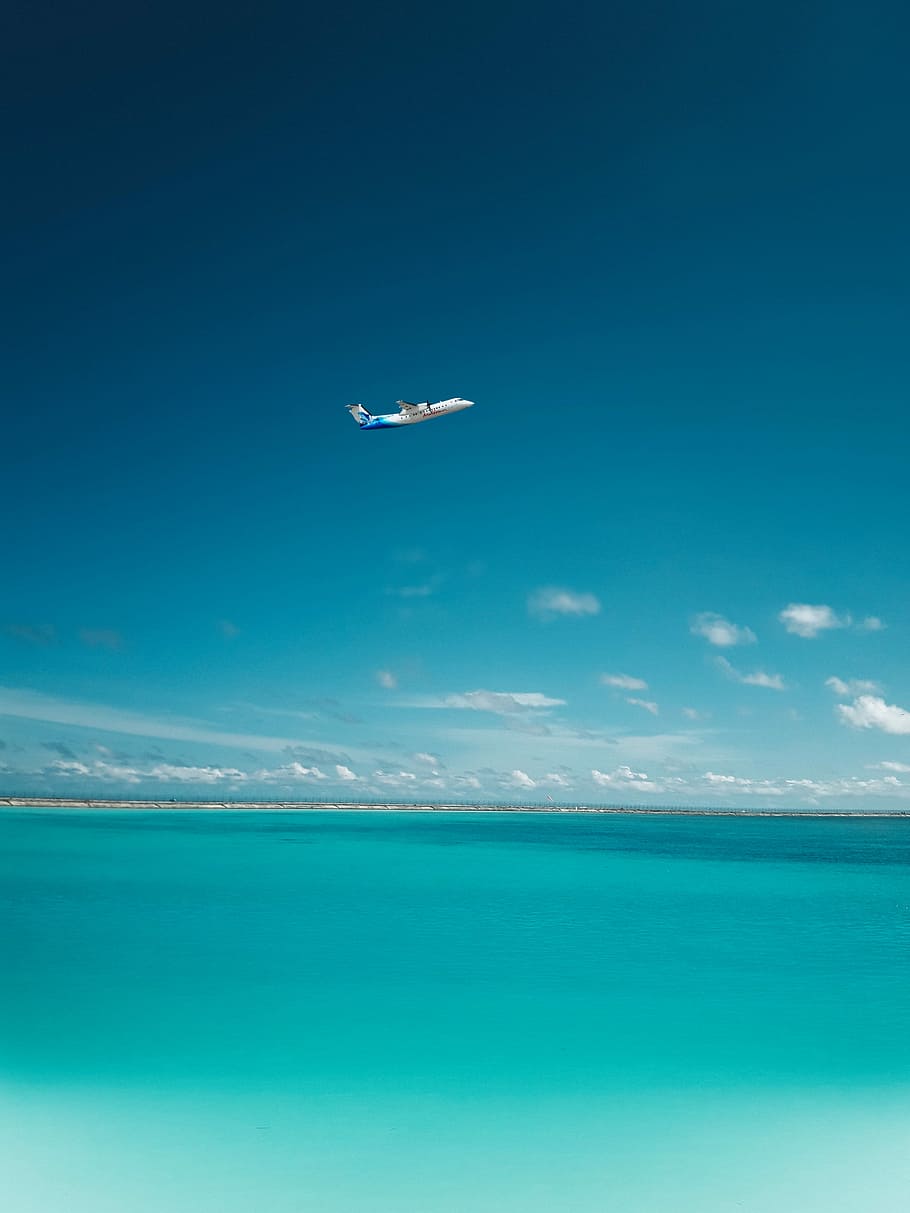 photo of airplane over body of water, commercial airplane in flight above blue ocean, HD wallpaper