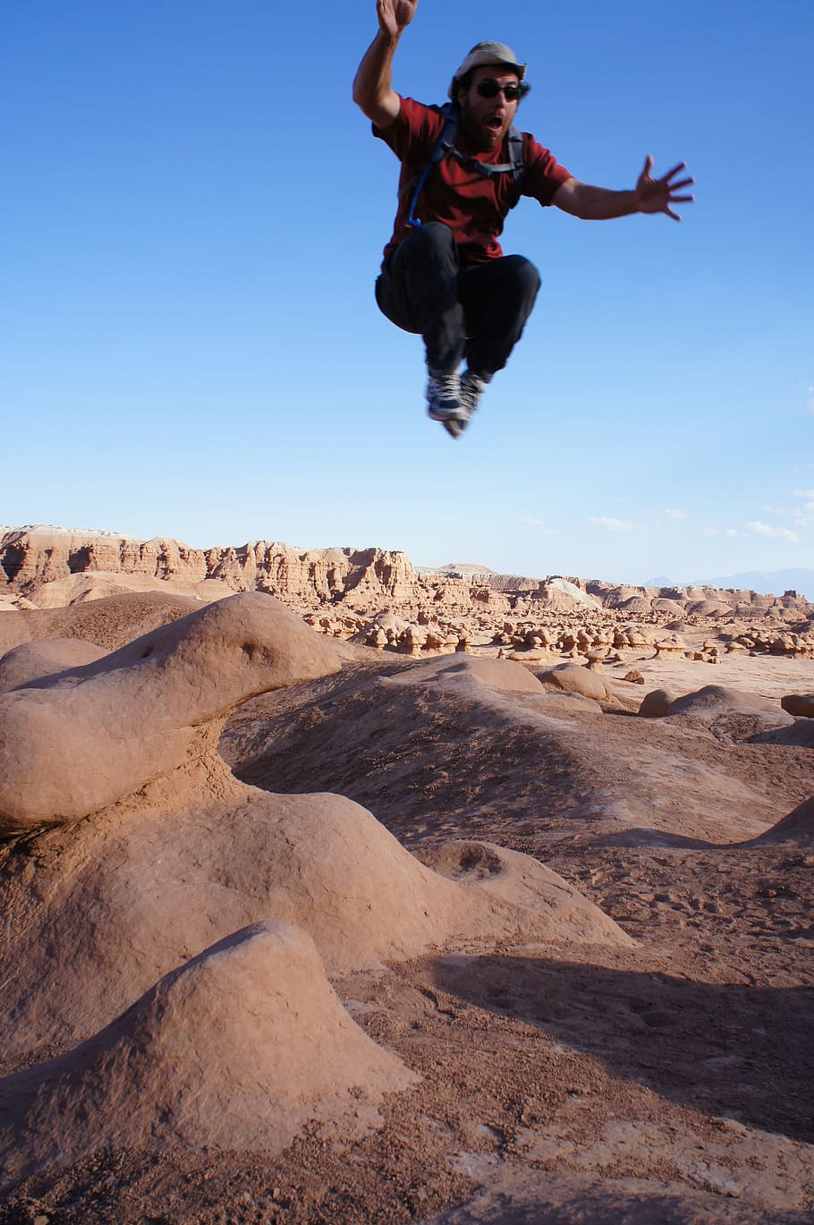 man jumped on desert during daytime, man posing for jumpshot at canyon HD wallpaper