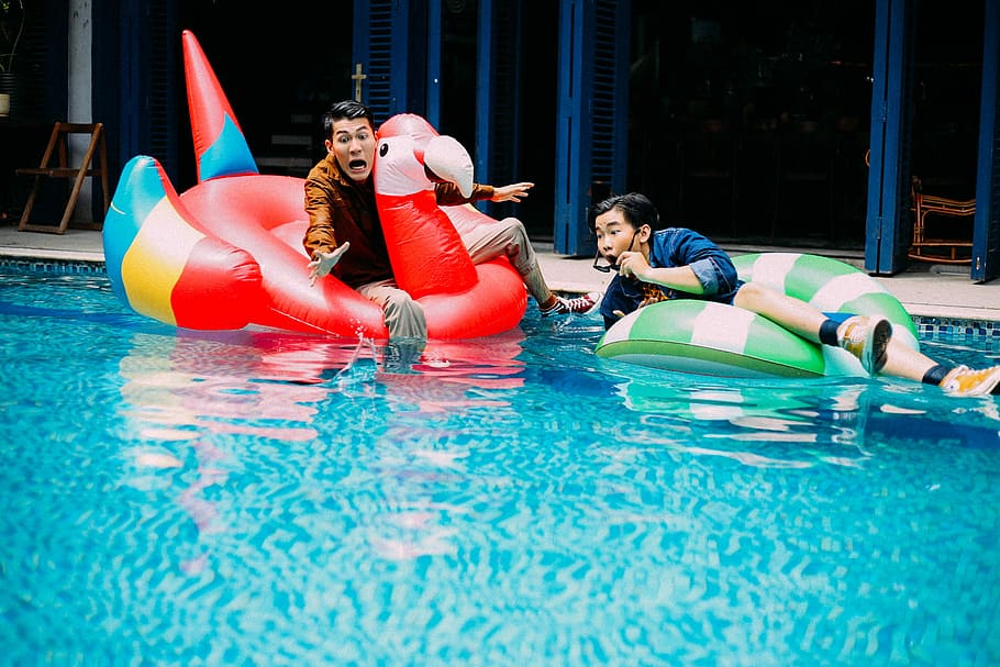 two men riding floaters in the pool, red, green, clear, fun HD wallpaper
