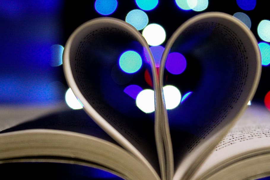 Photo of Bookpages Folded Into Heart Shape With Bokeh Light Background HD wallpaper