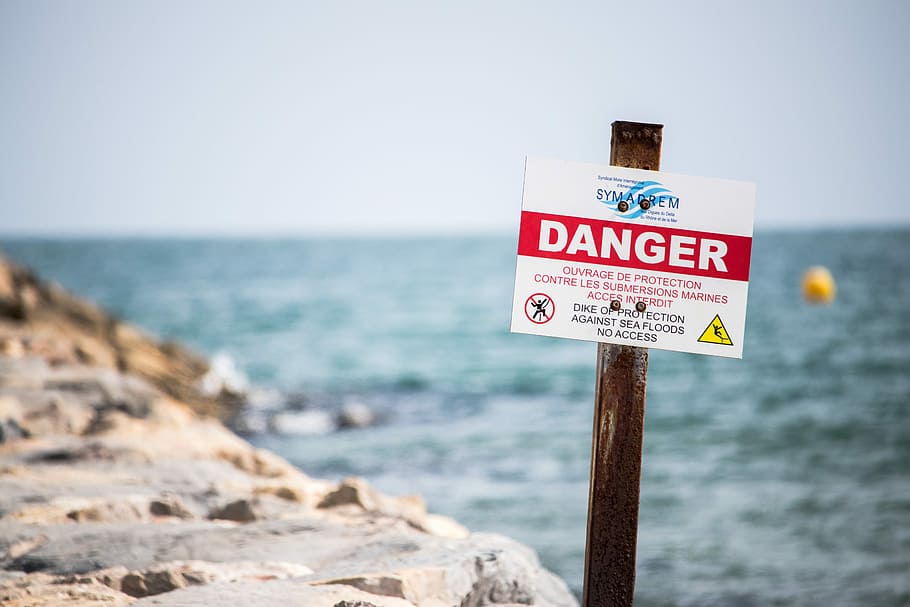Danger signage over body of water, Beach, Warning, Dike, floods HD wallpaper