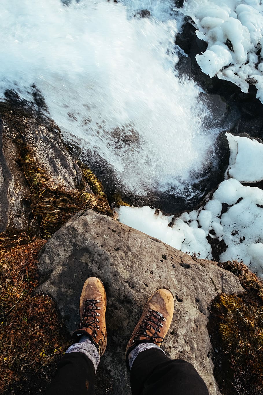 person standing on top of cliff, person standing on rock, waterfall HD wallpaper