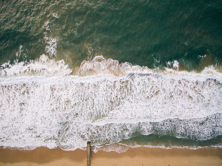 top view photography of brown beach sand with teal ocean water during daytime, blue beach seashore top view photo taken during daytime HD wallpaper