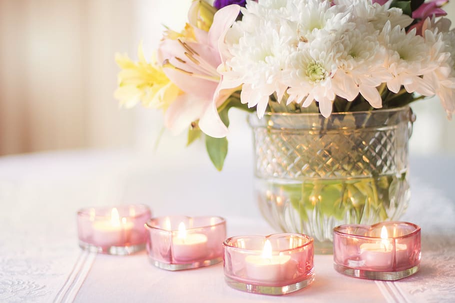white petaled flowers and four pink tealight candles, valentines day