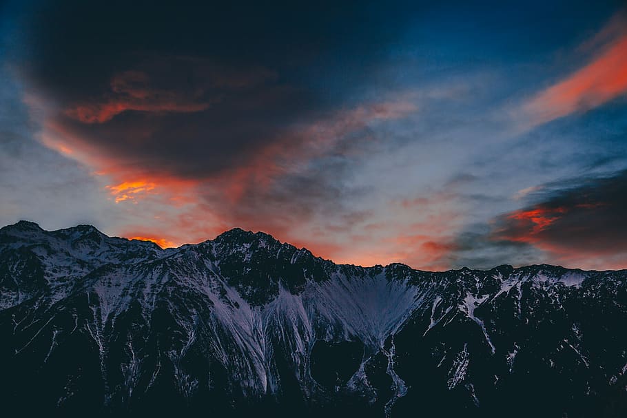 landscape photography of mountain covered with snow during dusk, snow-covered mountain under cloudy sky HD wallpaper