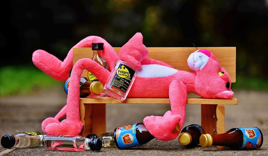 pink panther plush toy lying on bench, the pink panther, drink