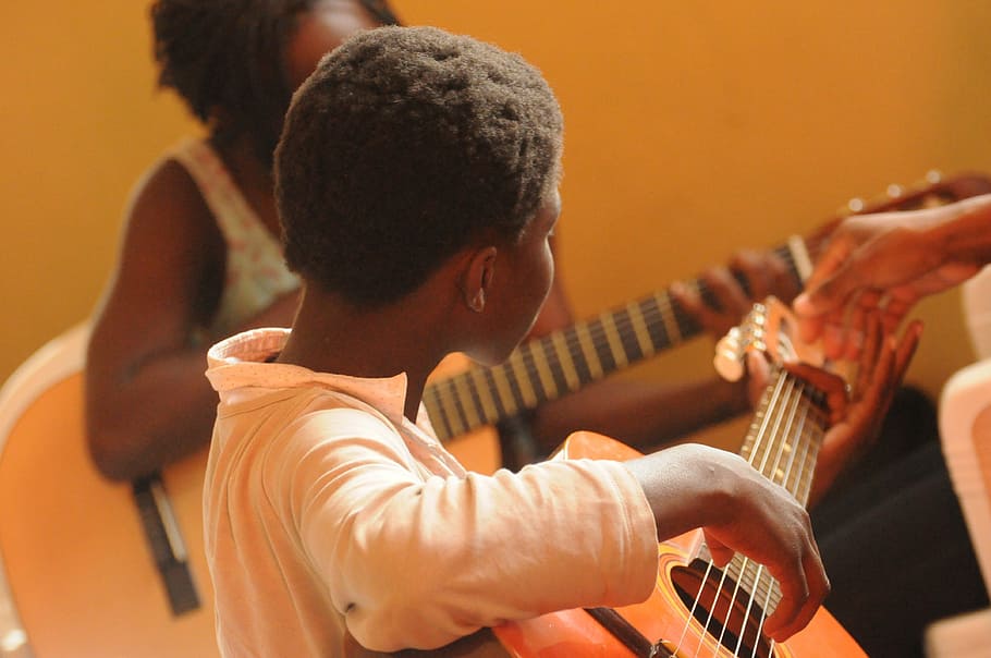 shallow focus photography of man playing guitar, africa, black