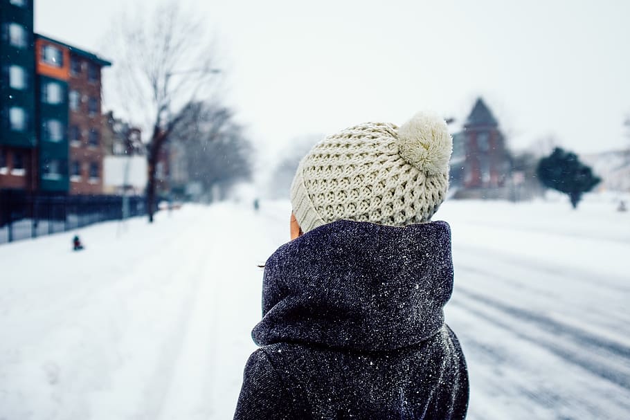 woman standing on snow covered road, shallow focus photography of person facing snow covered road HD wallpaper
