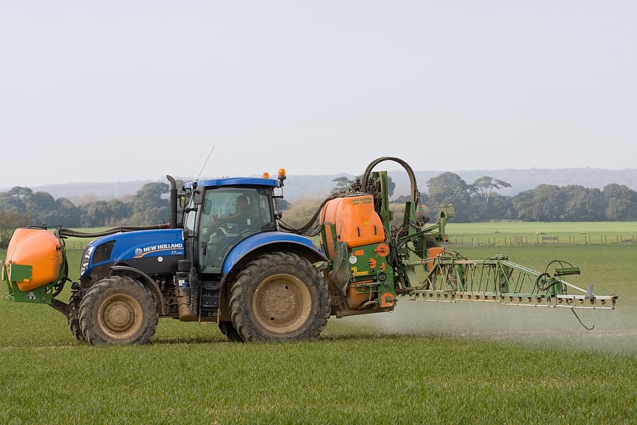 blue and yellow tractor on grass field, spraying, crop spraying HD wallpaper