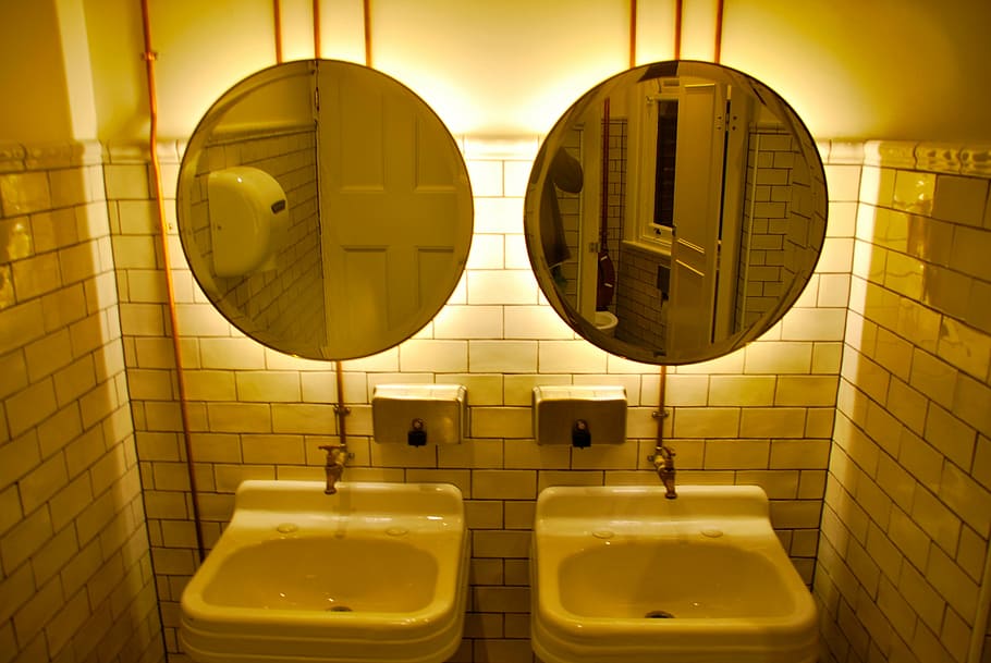 two round gray metal framed wall mirrors and sinks on bathroom HD wallpaper