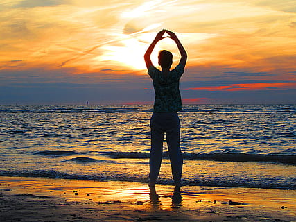 person standing on beach while rising his hand, boy, sun, sea HD wallpaper