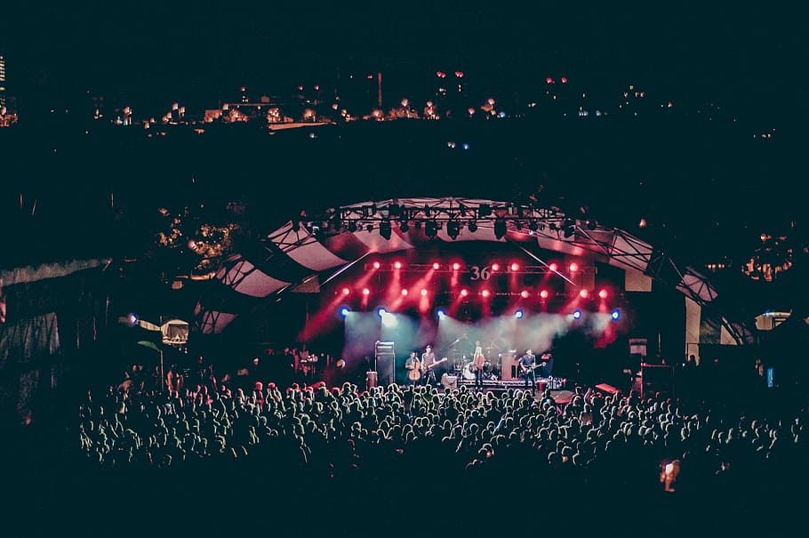 male bands performing on stage infront of people during nighttime HD wallpaper
