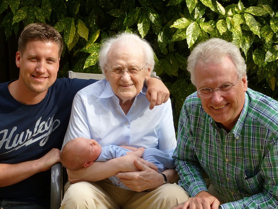 three men taking picture with a baby during daytime, family, generations