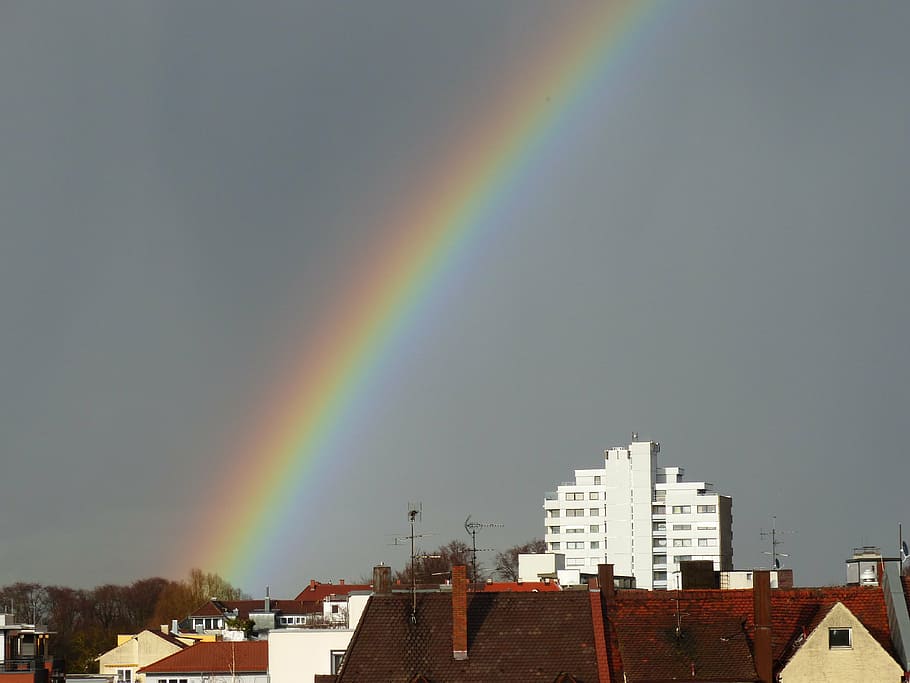 rainbow above white concrete building, weather phenomenon, sky