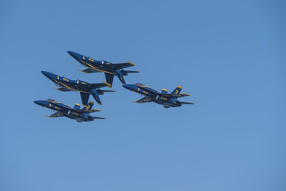 four blue-and-yellow aircrafts performing air show trick, four blue fighter jets in the sky HD wallpaper