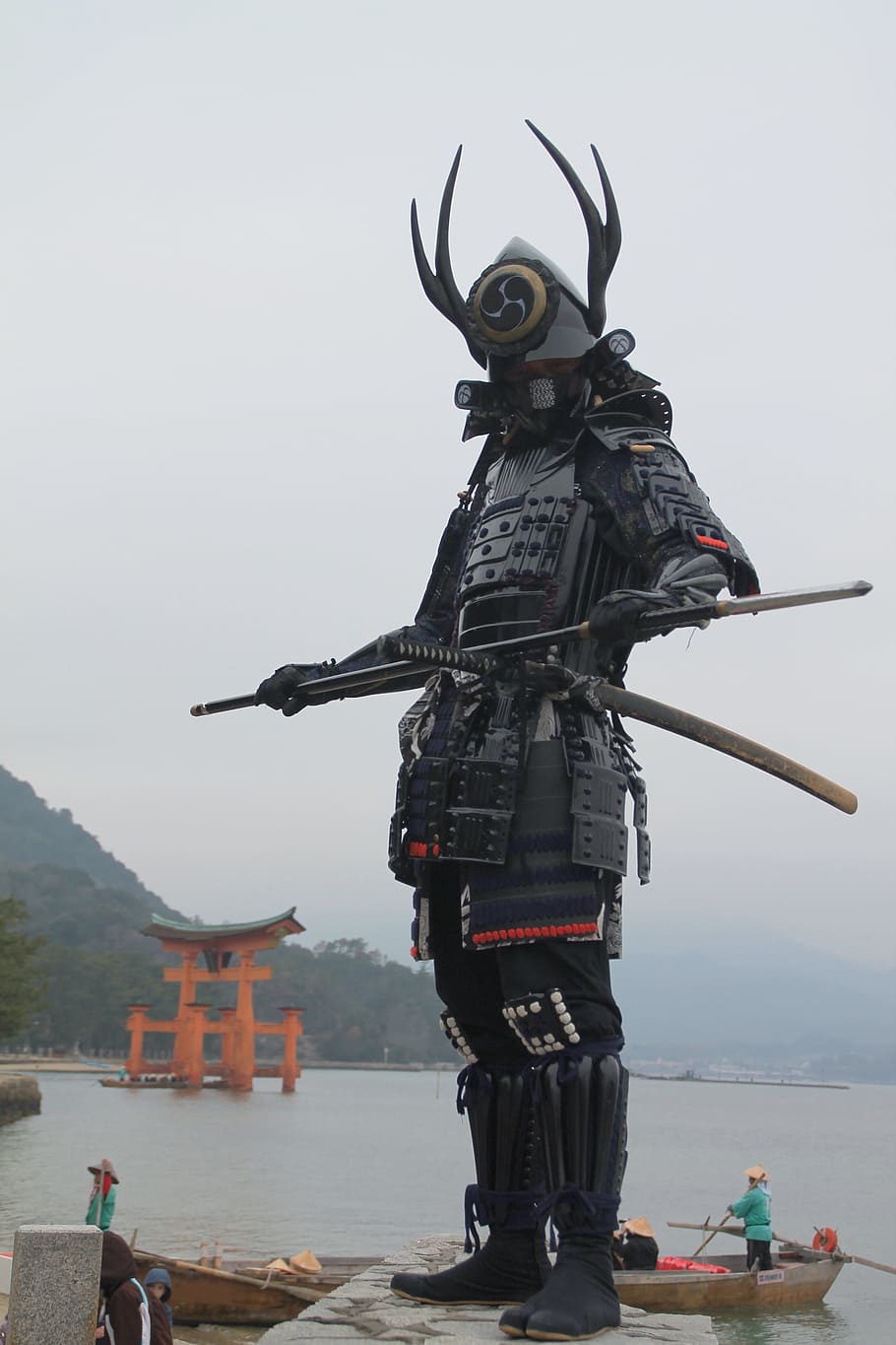 Samurai on gray concrete near body of water during daytime, miyajima