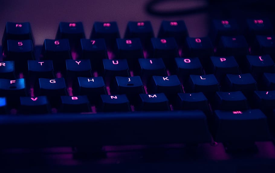 focus photography of computer keyboard with red lights, closeup view of black computer keyboard