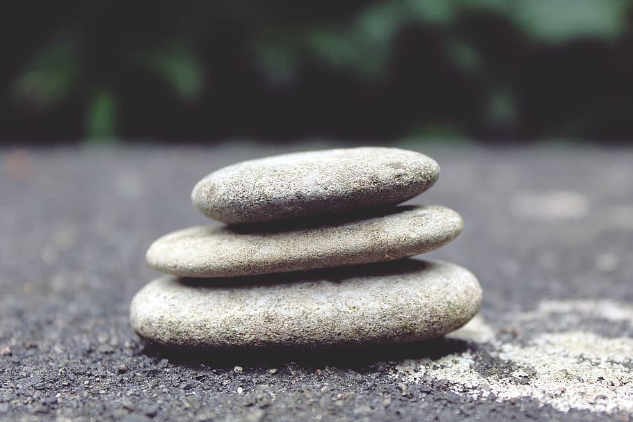three gray stone piled on gray sand, stones, decorative stones