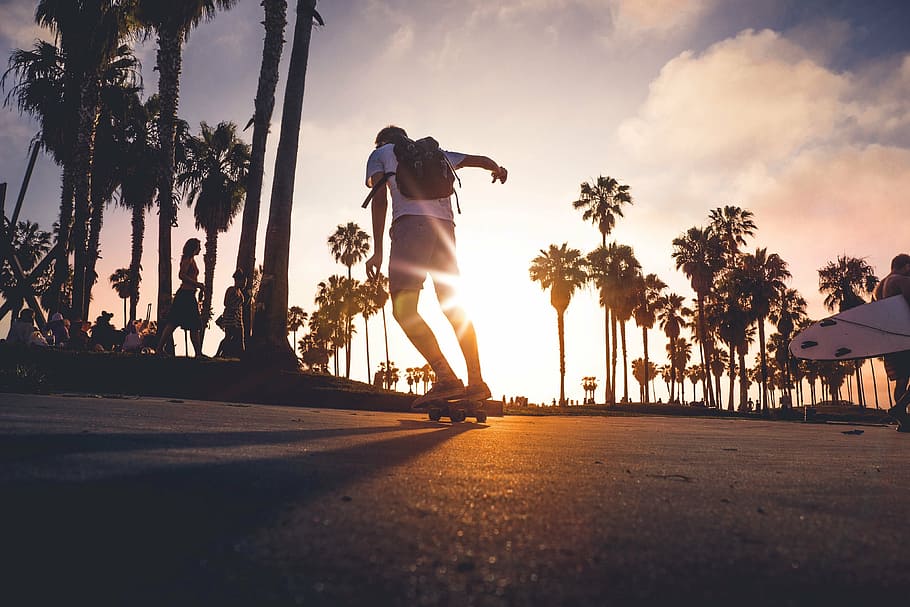 man skateboarding in street, sunset, outdoor, young, skateboarder