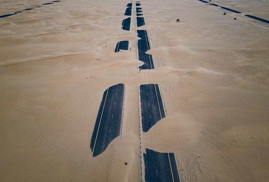 two highway road covered with sand, top view of hi-way on desert