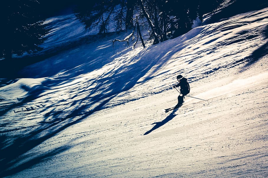 man using snow ski, person skiing down slope, mountain, skiier