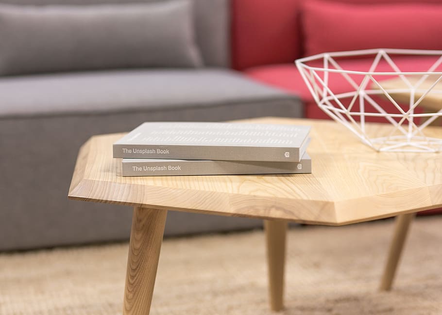 two books on wooden coffee table near sofa, gray, unsplash HD wallpaper