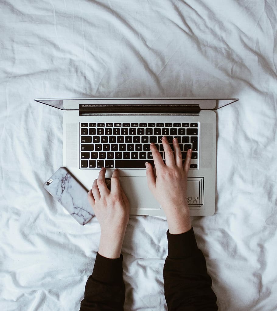 person using laptop computer, person hand on laptop beside smartphone HD wallpaper