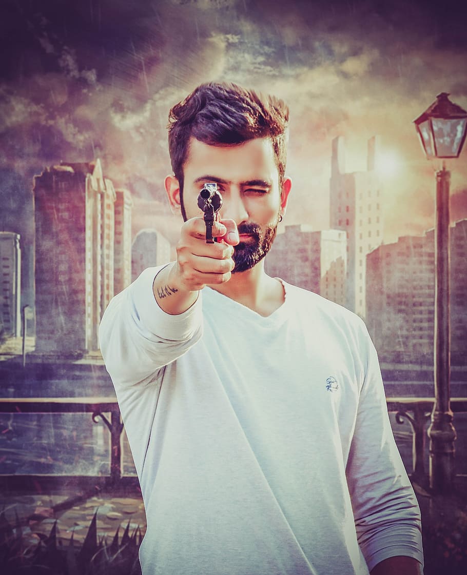 man pointing pistol beside wall with building and railings painting HD wallpaper