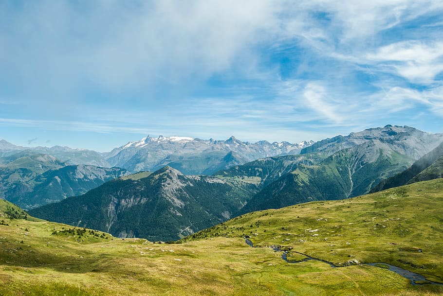 green grass field in the mountain, aerial photo of green field near mountain ranges HD wallpaper