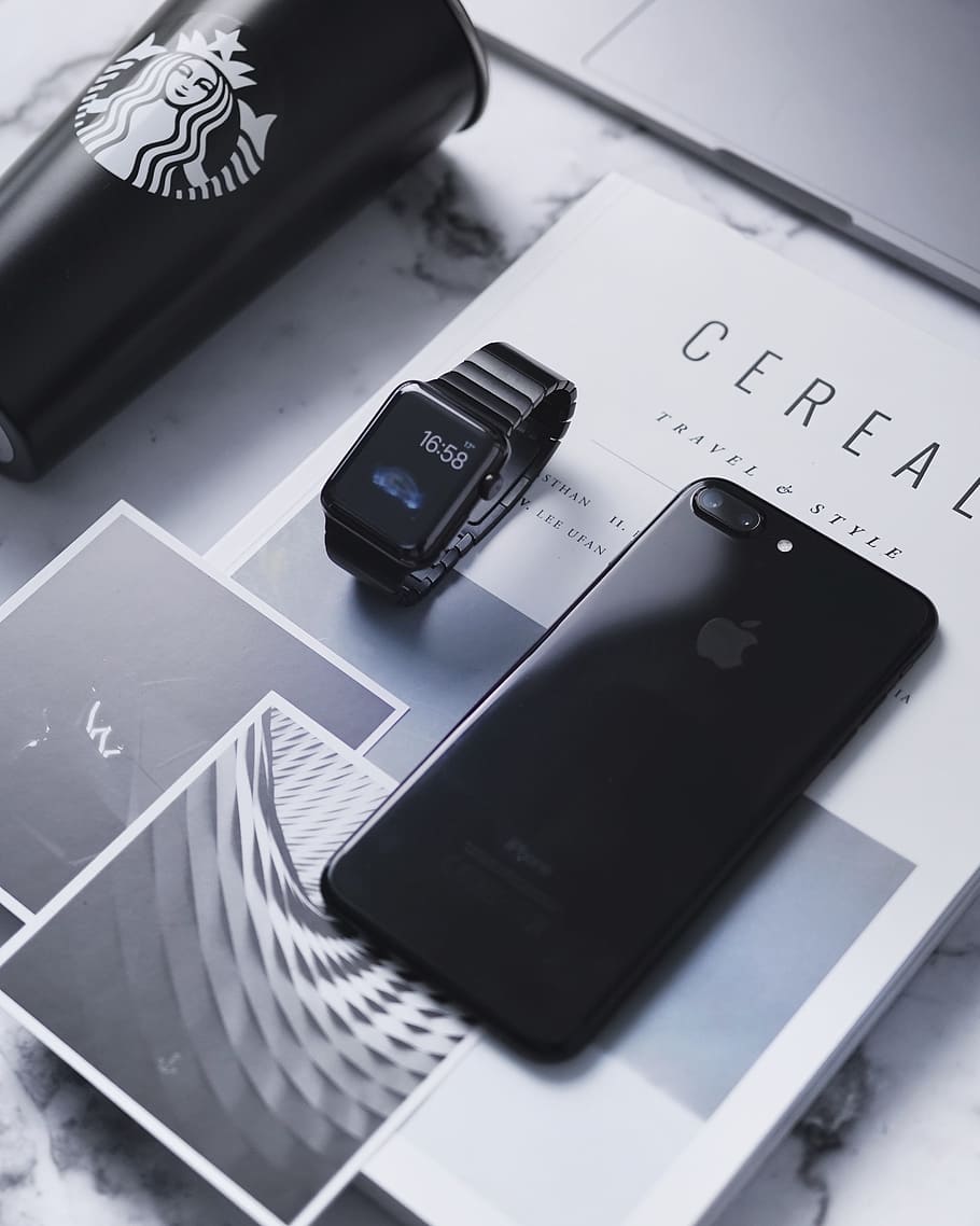 space gray iPhone 8 Plus beside space black aluminum case Apple Watch, flat lay photography of space gray iPhone 8 Plus beside Apple Watch and cup of Starbucks