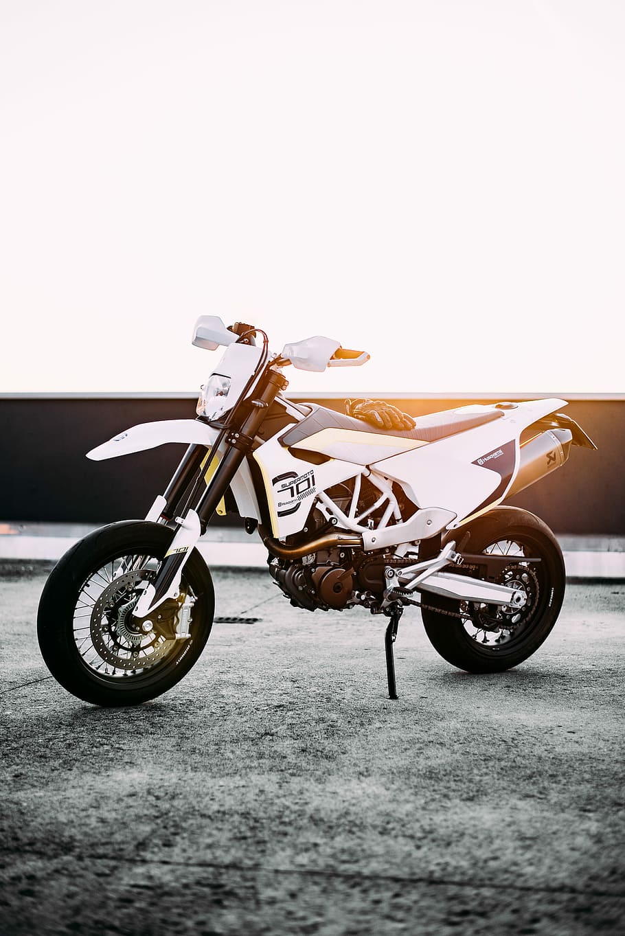 Dope., white and black dirt bike parked on gray concrete pavement