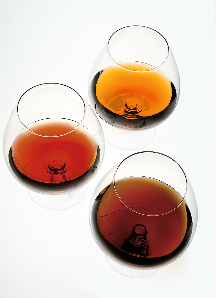 Premium Vector | Grape brandy in shot glass dark brown watercolor background  vector art