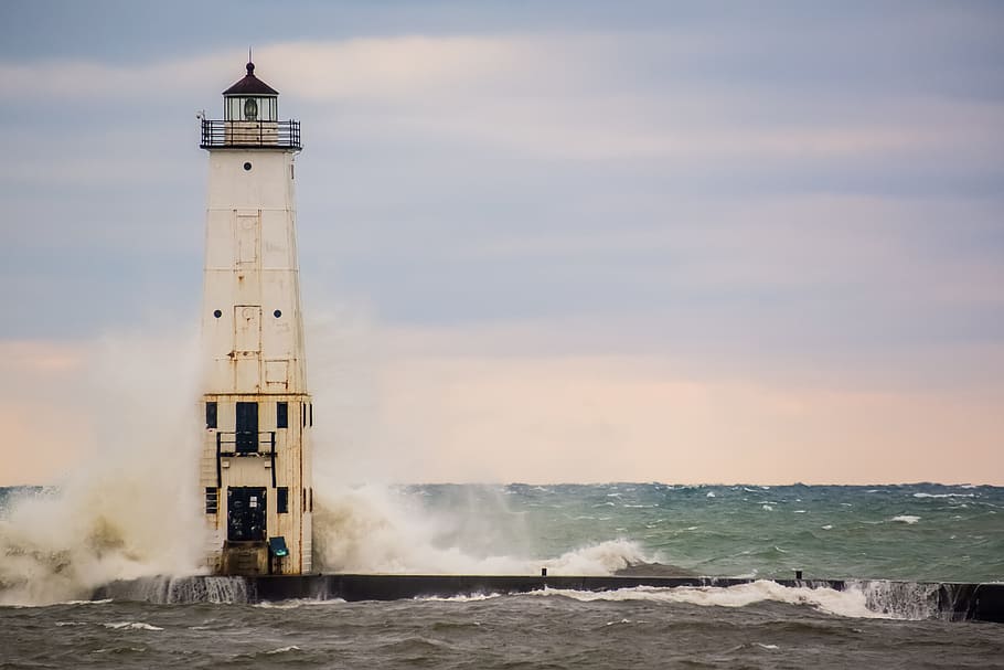 white and black lighthouse with water splashing as a background HD wallpaper