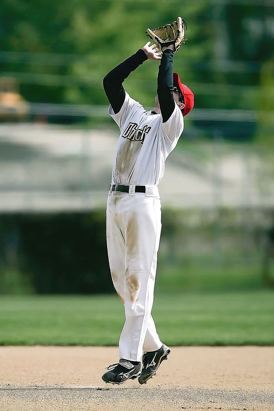 Download A Baseball Player Is Catching A Ball Wallpaper