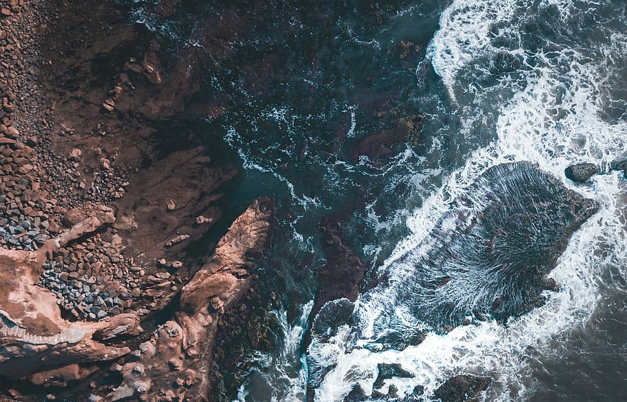 ocean whitewash photography, aerial photography of body of river beside brown rock HD wallpaper
