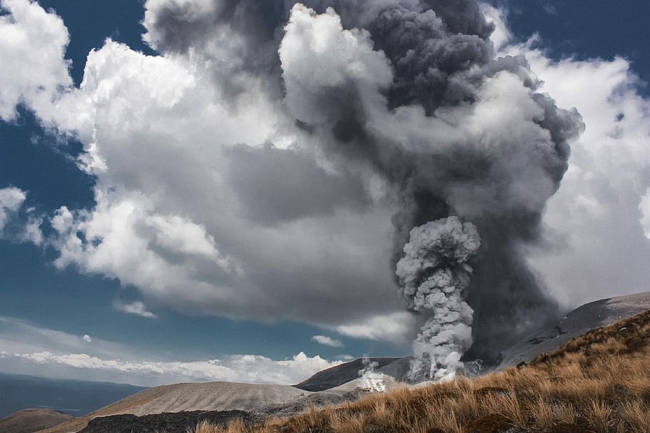 smoke rising towards the sky near brown grass field, white and gray smoke coming out from a hill HD wallpaper