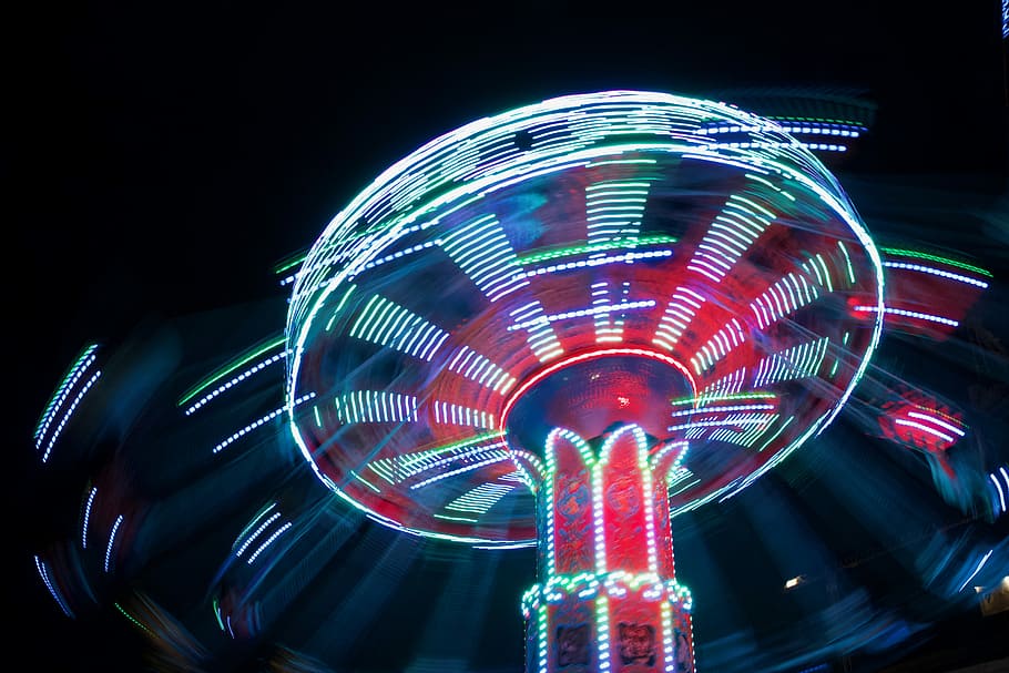 lighted ride-on carousel, lighted red and white carnival tower