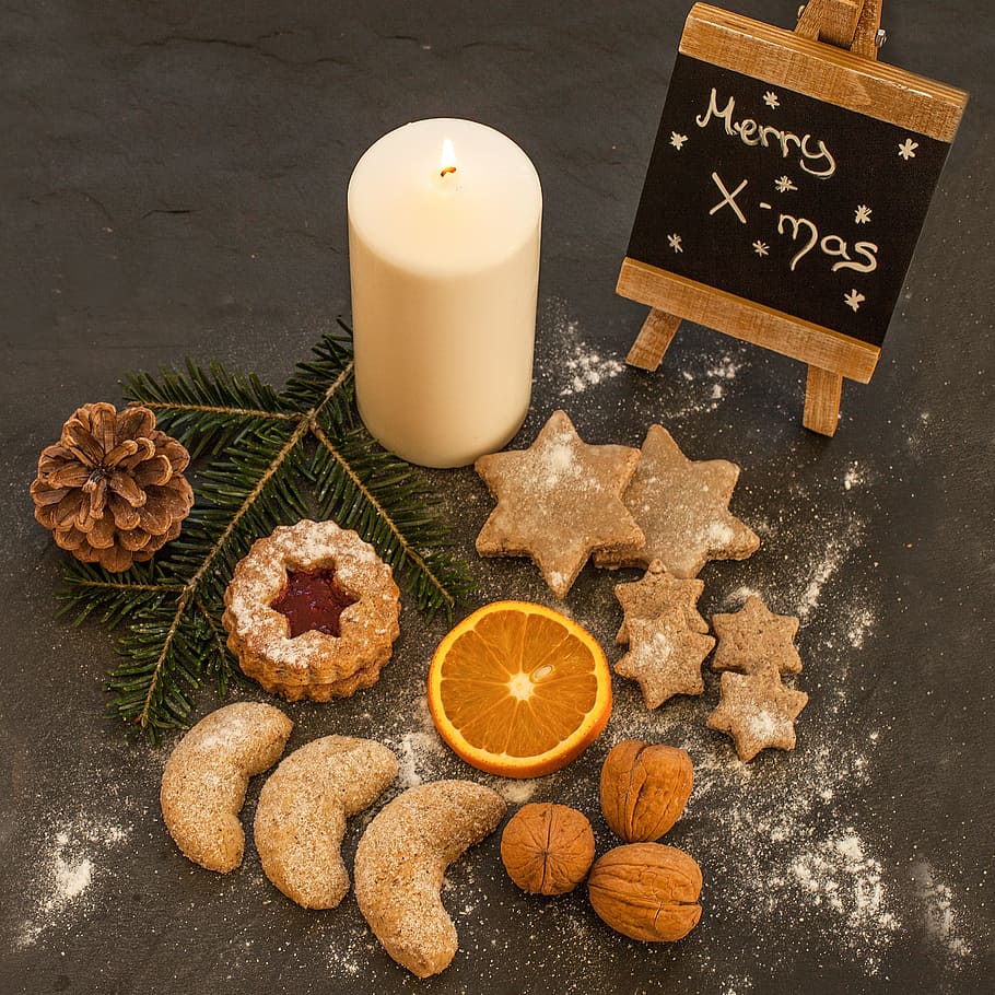 flat lay photography of baked pastries placed near pillar candle