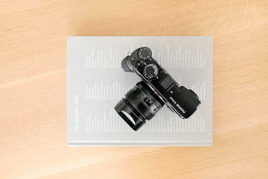 black DSLR camera on top of book, lens, photography, table HD wallpaper