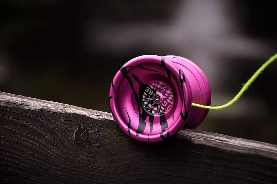 selective focus photography of pink and white yoyo, strings, hobby