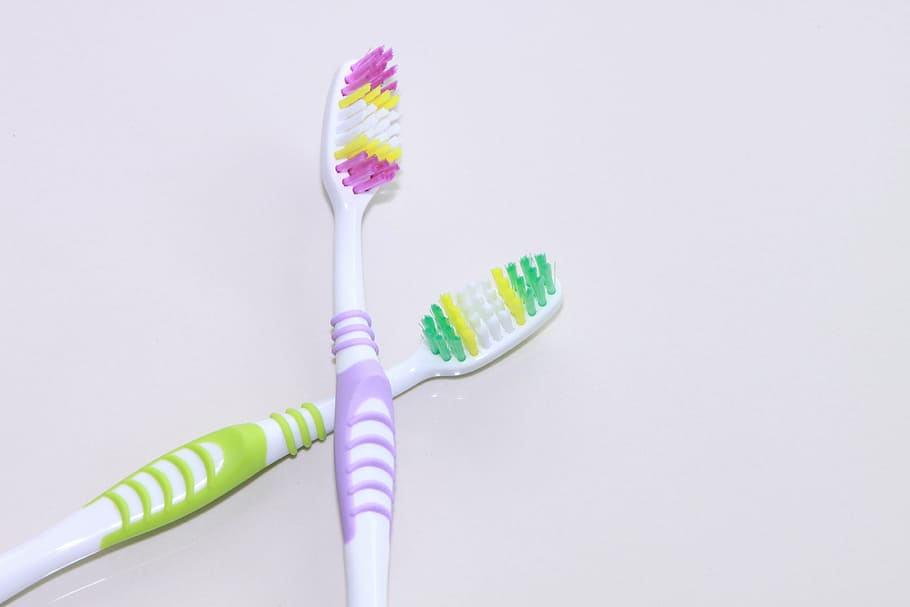 two purple and green toothbrushes, colgate, colored, dental, hygiene, HD wallpaper