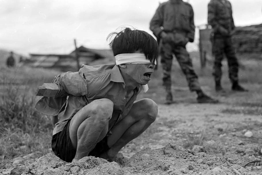Viet Cong prisoner captured in 1967 by the U.S. Army awaits interrogation during Vietnam War