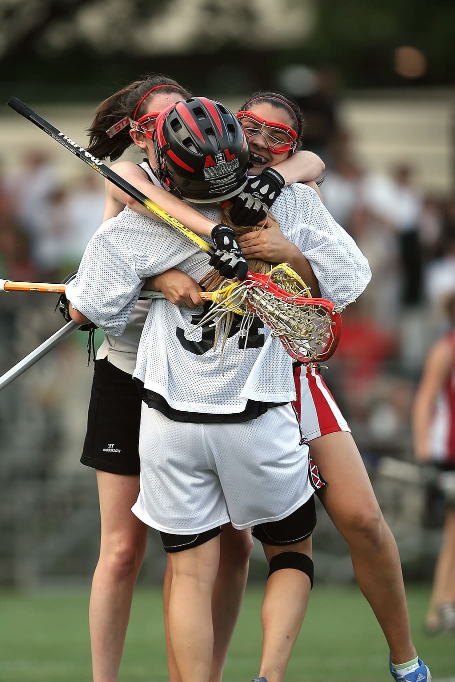 three people hugging each other at daytime, lacrosse, lax, sport