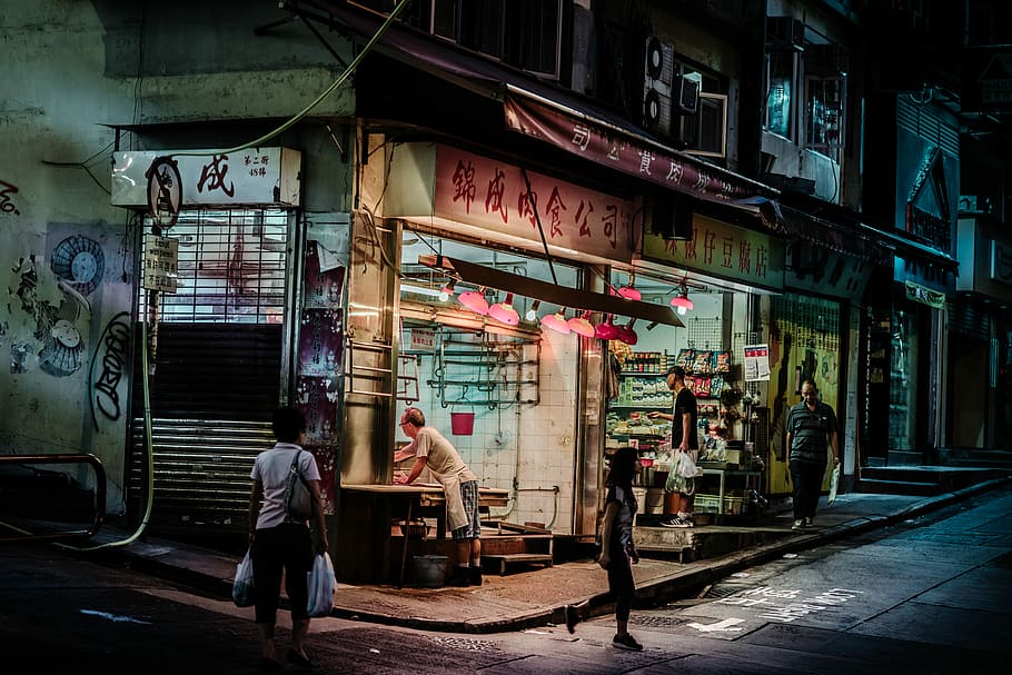 When the night falls in Hong Kong, woman carrying two plastic bags HD wallpaper