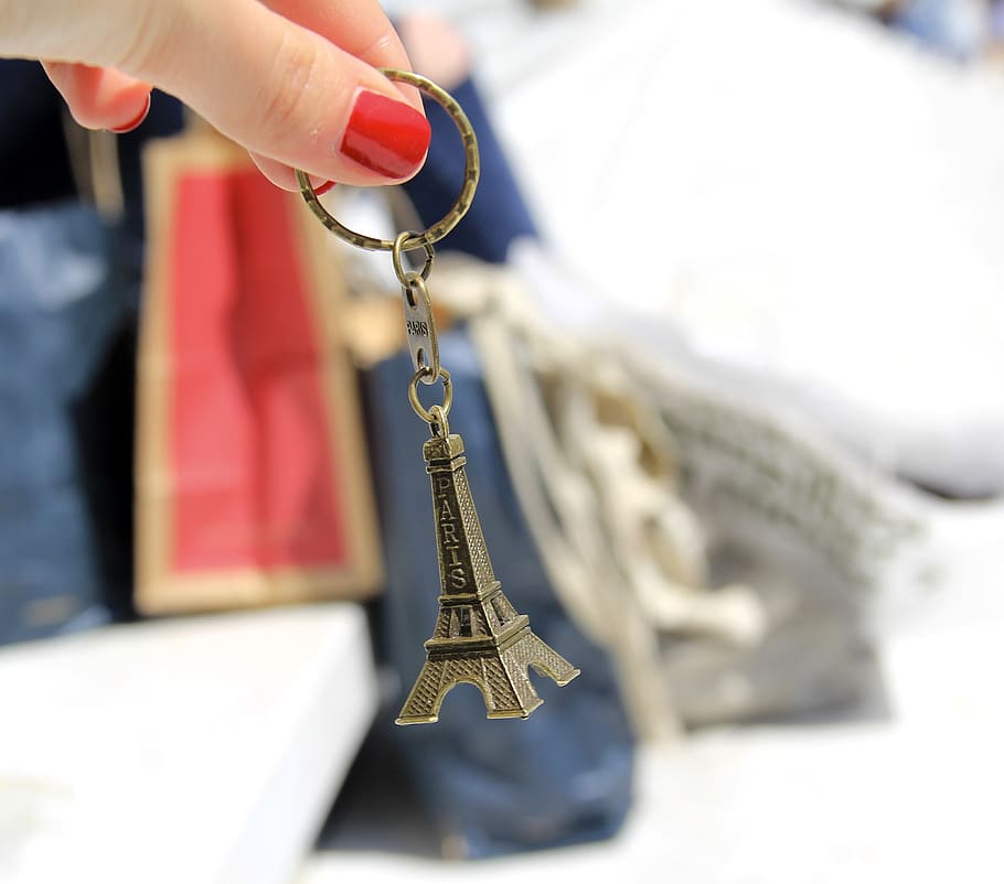 person holding silver Eiffel Tower keychain, paris, shopping, HD wallpaper